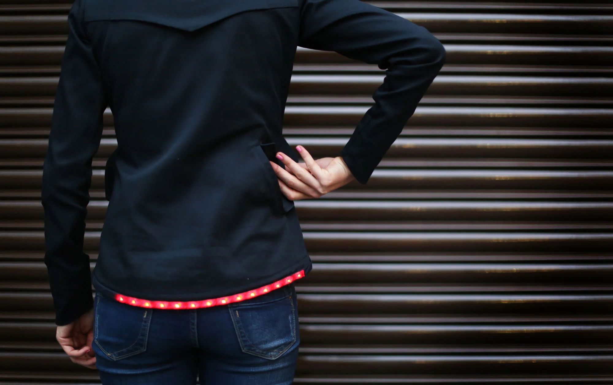 Woman placing something in back pocket