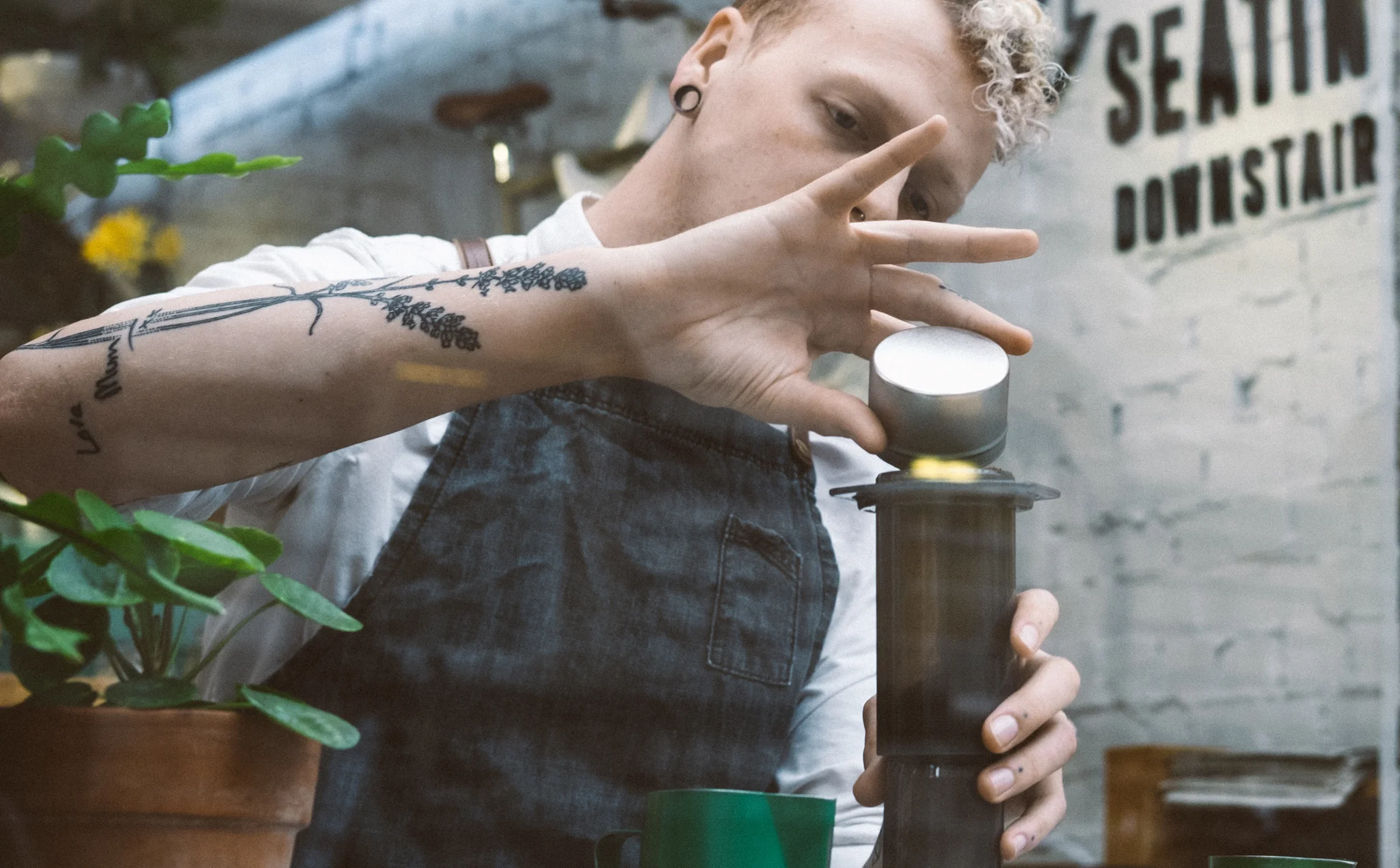 Barista making coffee using the AeroPress, used in their website design