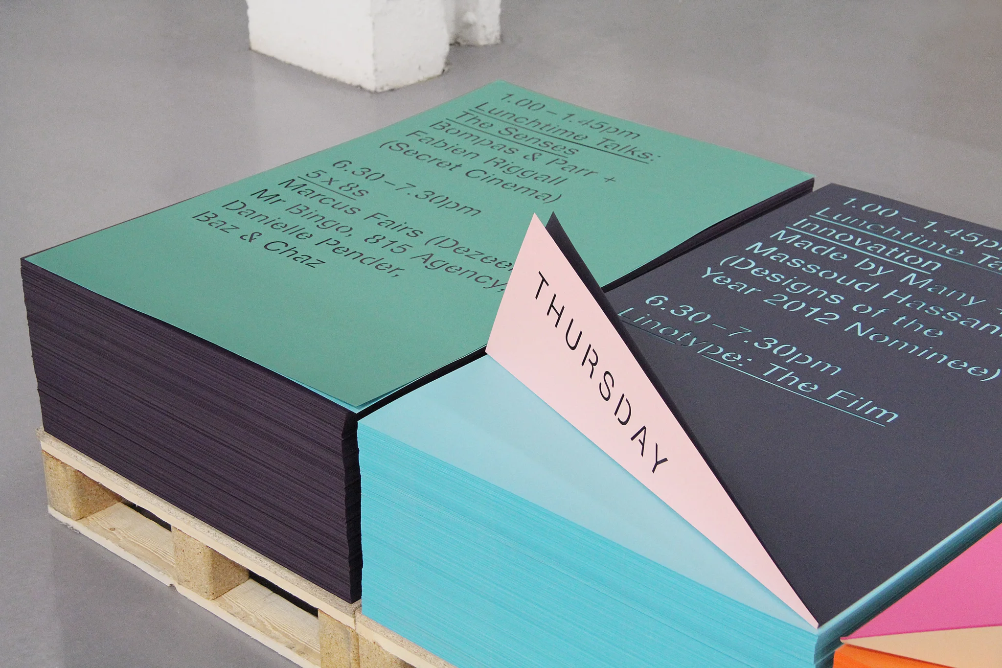A wooden pallet full of leaflets advertising the date and time of GFSmith Beauty in the Making