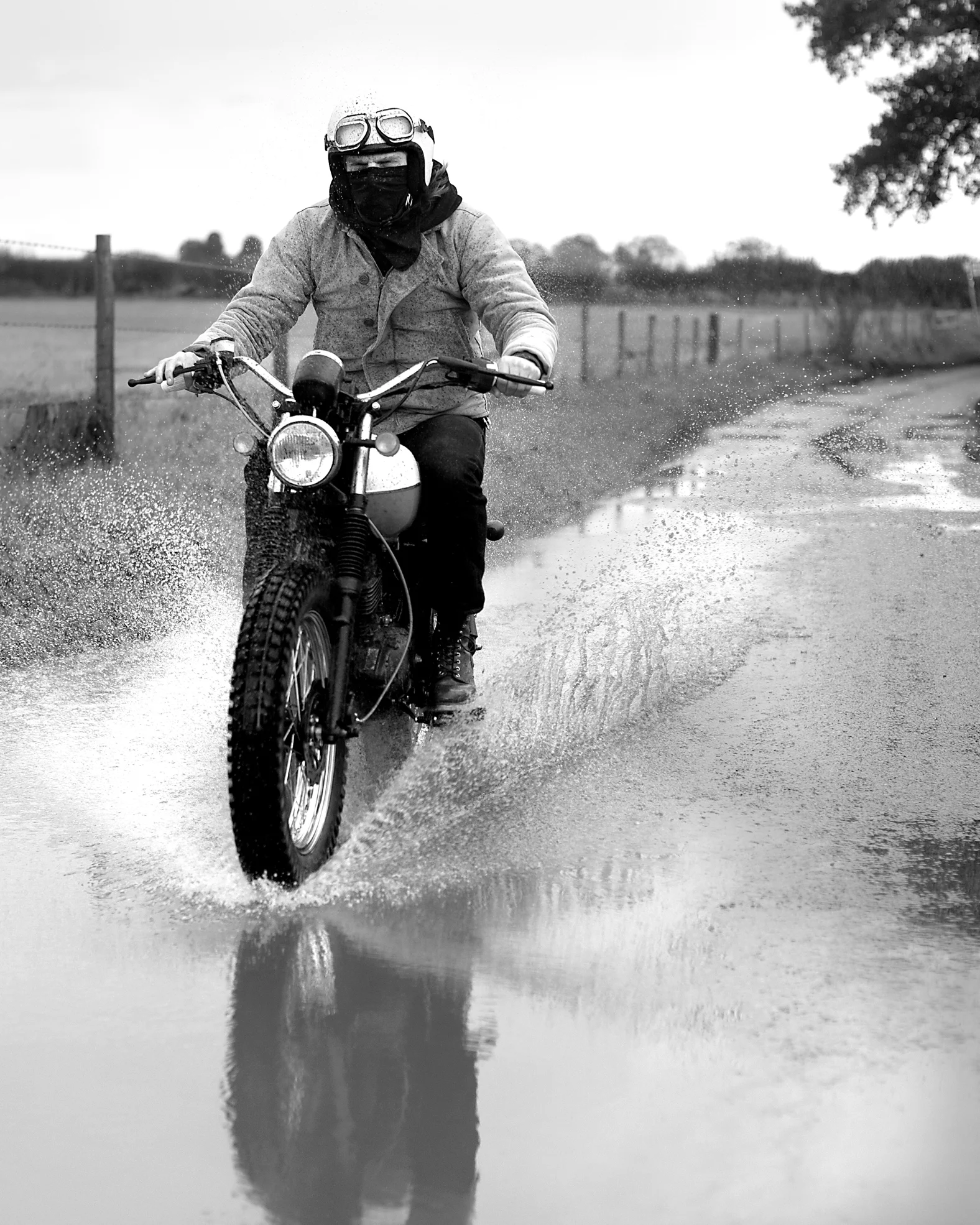 Thumbnail of a Mutt Motorcycle driving through puddle on a country road